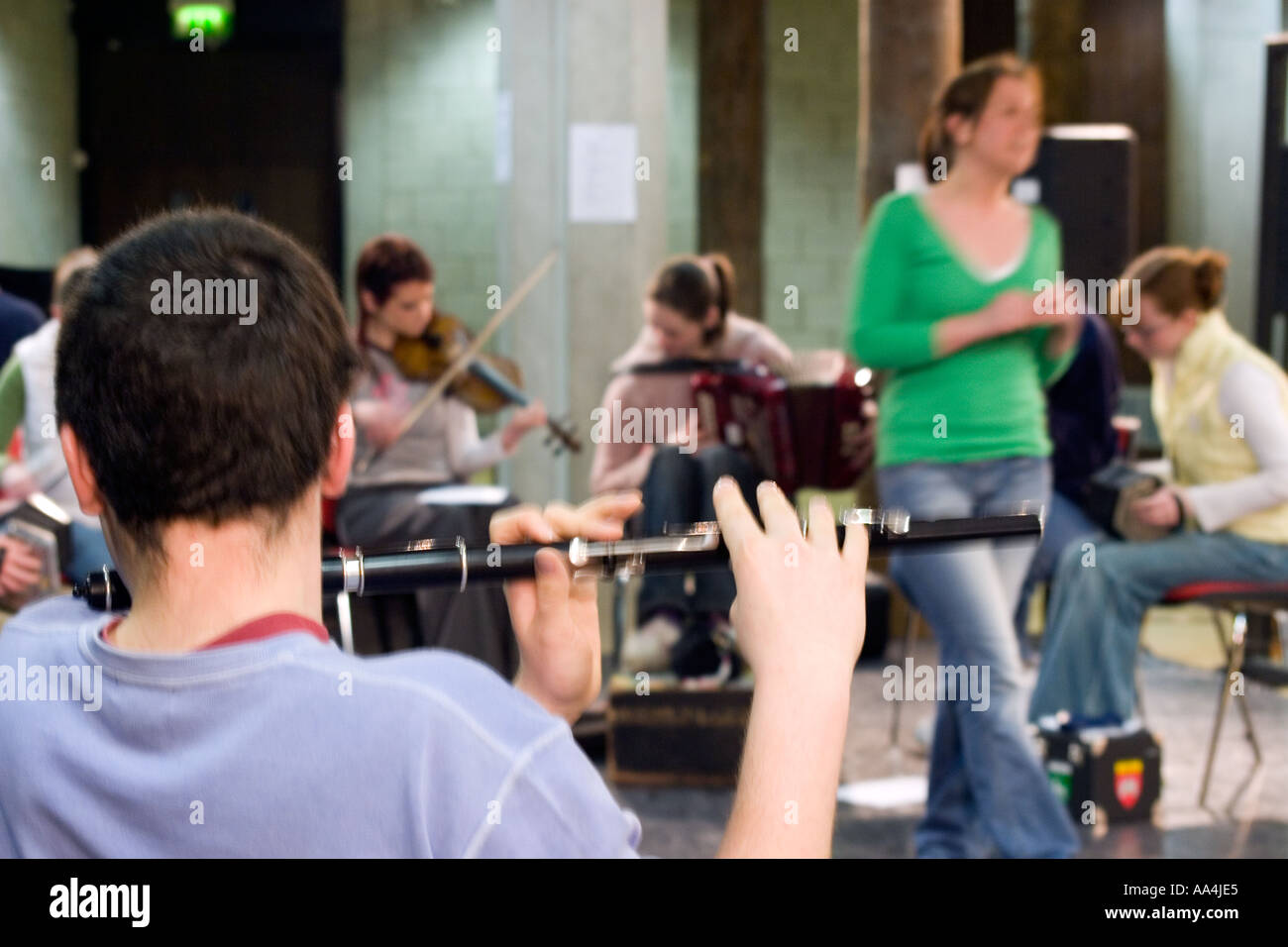 Male Irish flute player seen from behind University of limerick Stock