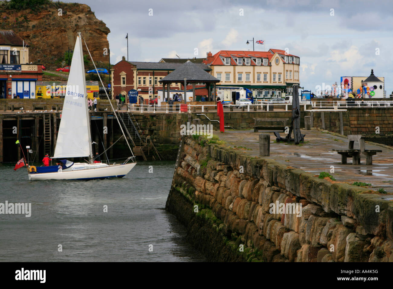 yacht heading for sea out of whitby harbour north yorkshire england uk ...