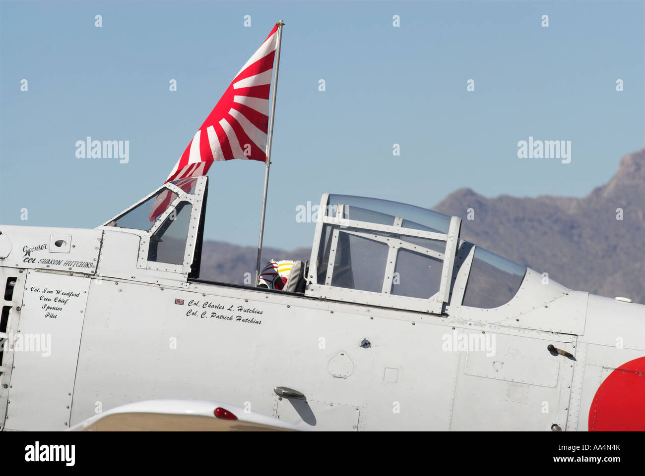 A Japanese Zero with the "Rising Sun" flag of Japan flying over it
