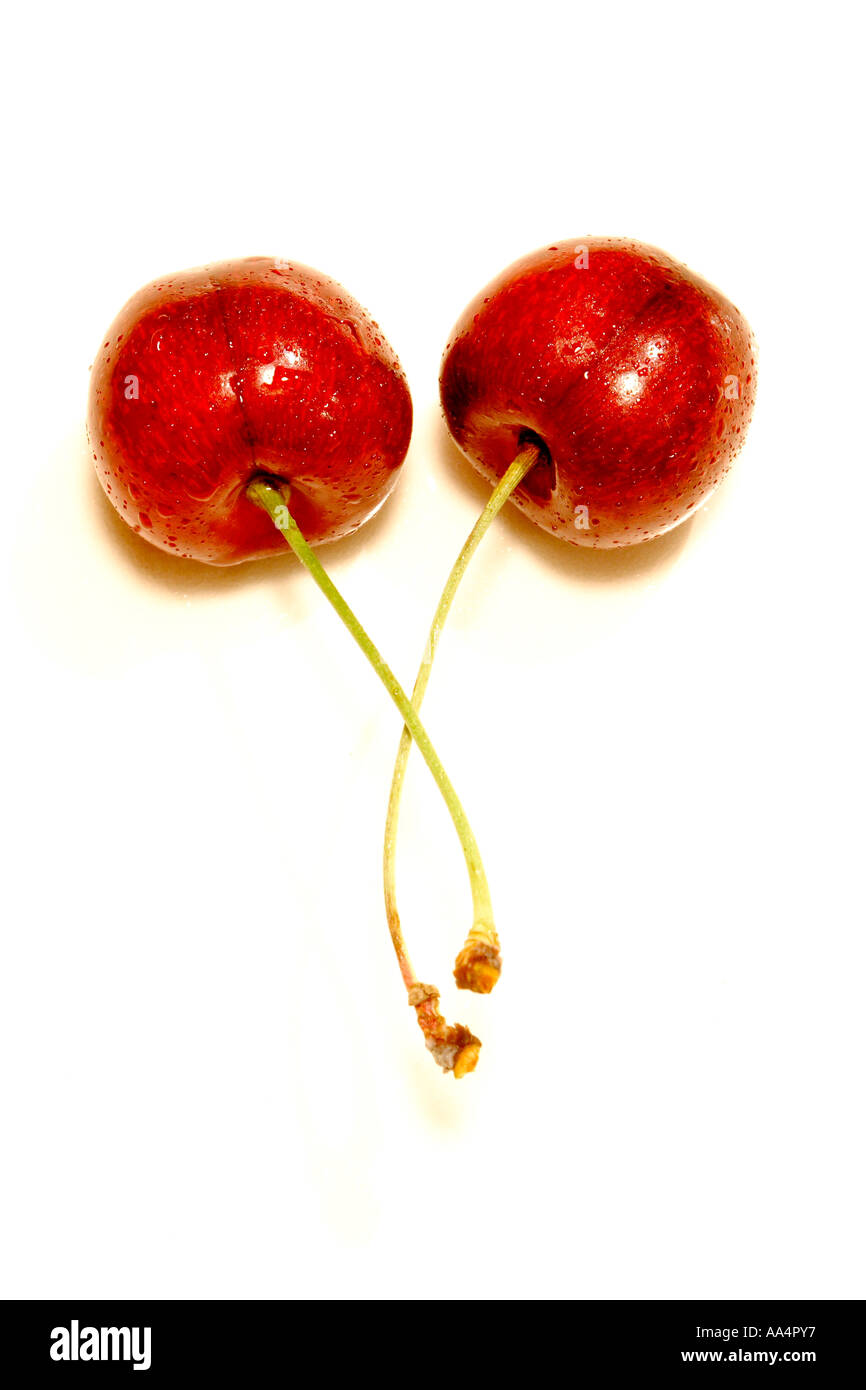 Two red cherries isolated on a white background Stock Photo - Alamy