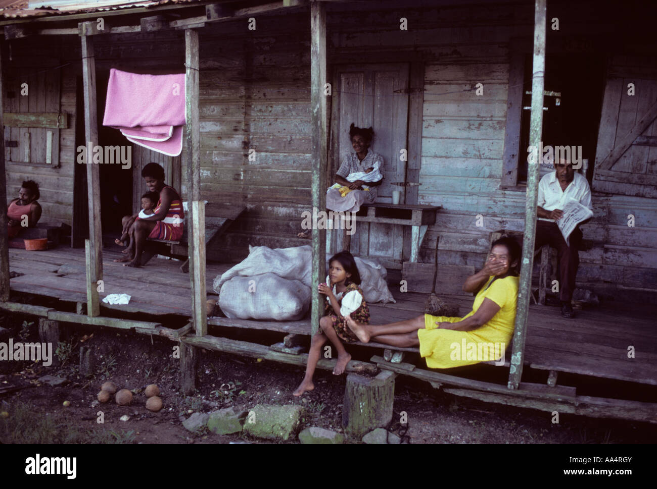Nicaragua Miskito coast poor family sitting on porch Stock Photo