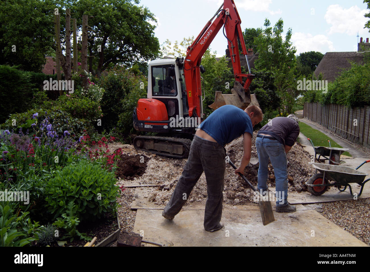 Mechanical digger working in a country garden Hampshire England UK