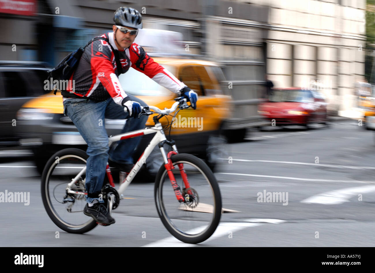 Young male bike messenger in traffic in New York City Stock Photo