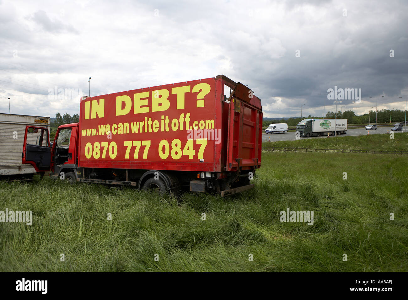 Advertisements on stationary vehicles parked in field next to the M62