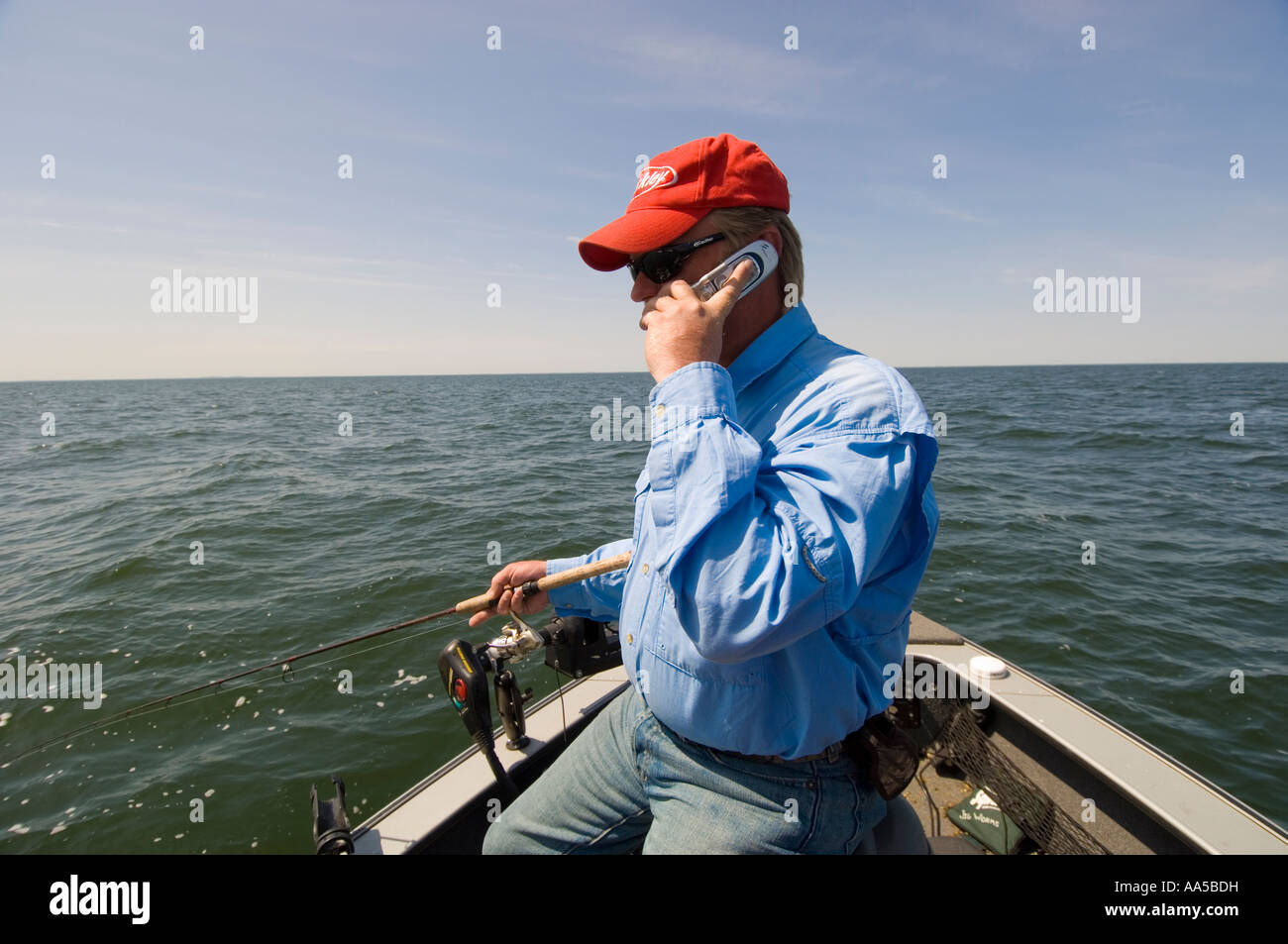 Fisherman talking on cell phone hi-res stock photography and