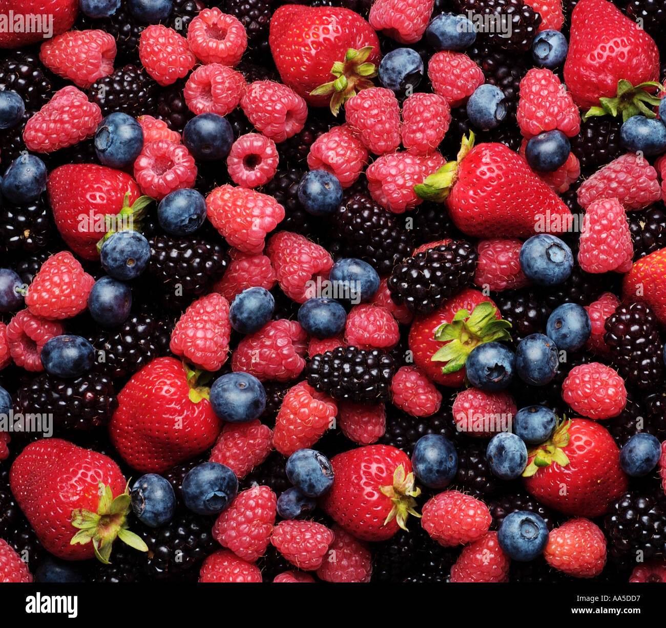 Background of strawberries blueberries raspberries and blackberries