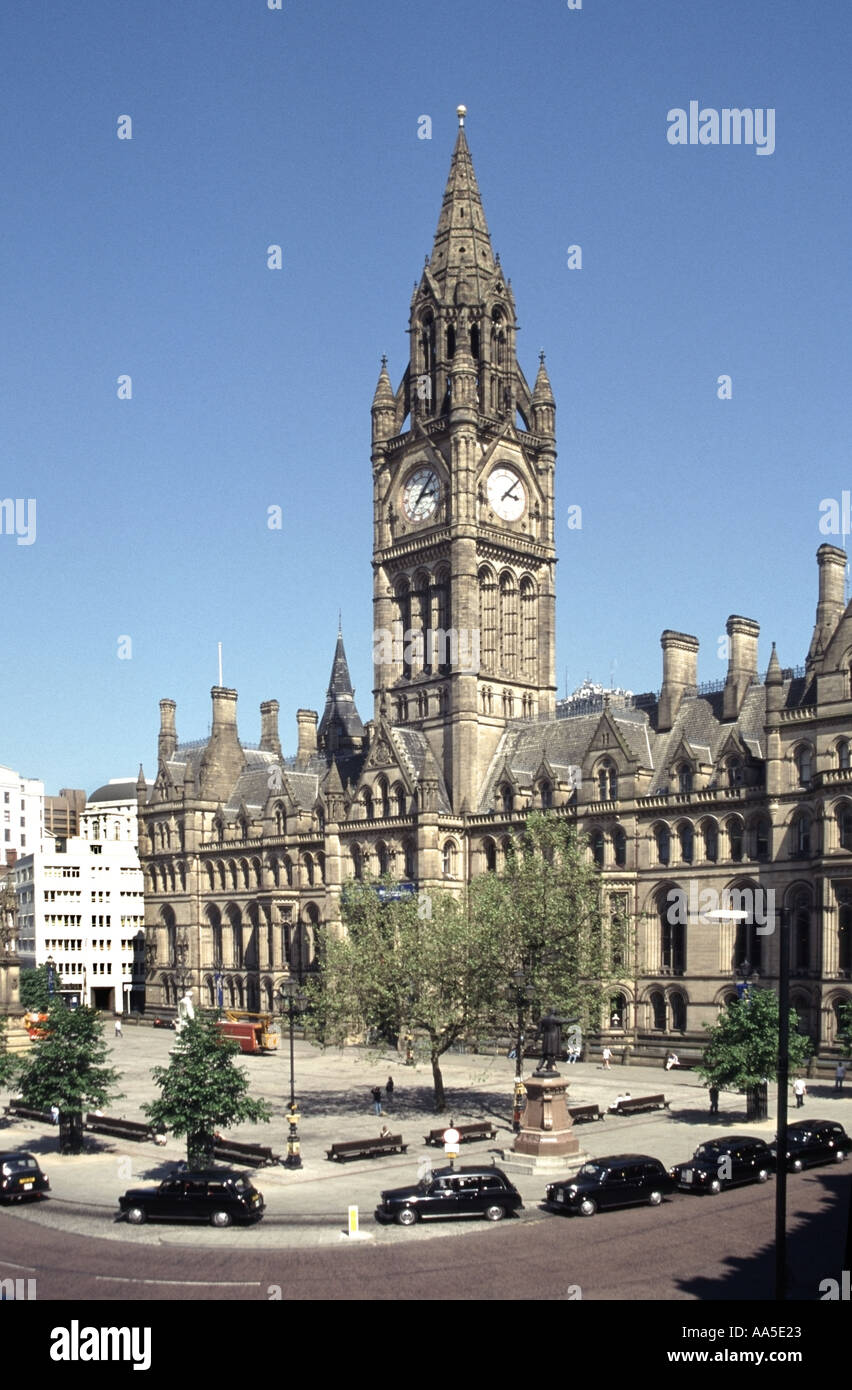 The Town Hall and Clock Tower with taxis in Albert Square in The metropolitan borough of Manchester England UK Stock Photo