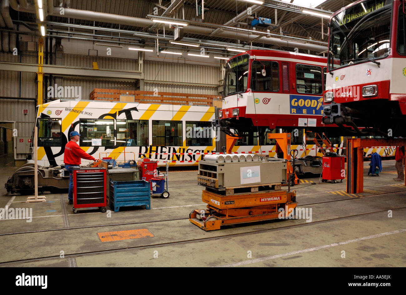 Inside the Rheinbahn tram workshops in Duesseldorf, Germany, showing 2 trams (Type B80) on the bogie-drop. Stock Photo