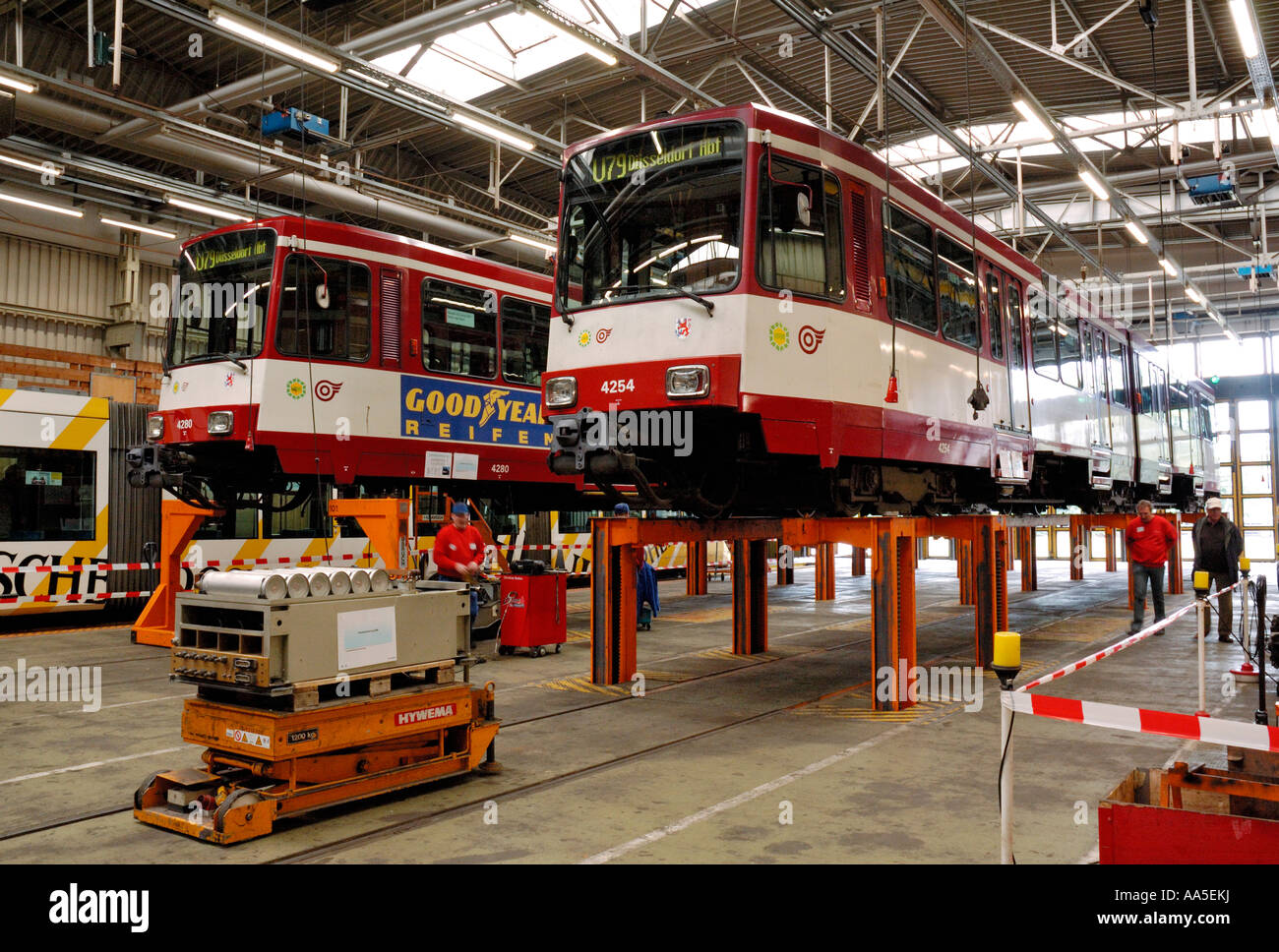 Inside the Rheinbahn tram workshops in Duesseldorf, Germany, showing 2 trams (Type B80) on the bogie-drop. Stock Photo