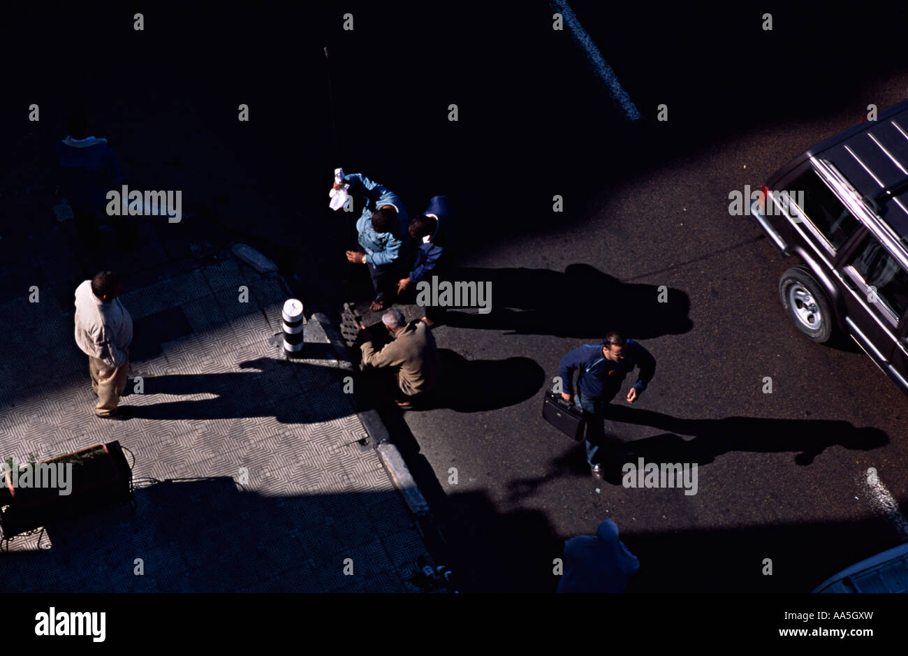 Men trying to unblock a drain on the main road Alexandria, Egypt. Stock Photo