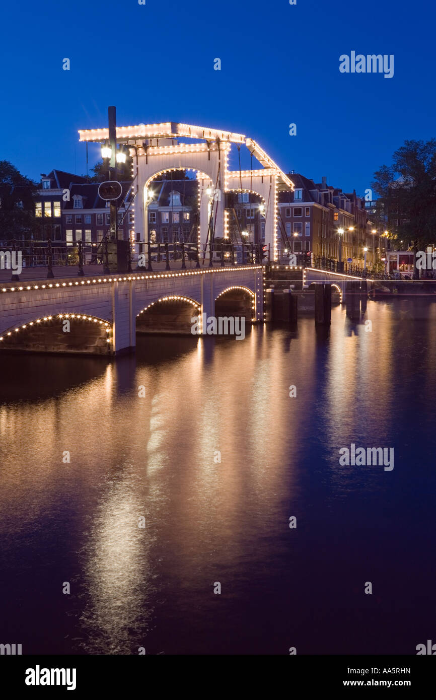 Amsterdam, Netherlands. Magere Brug also known as Skinny Bridge Illuminated at dusk Stock Photo