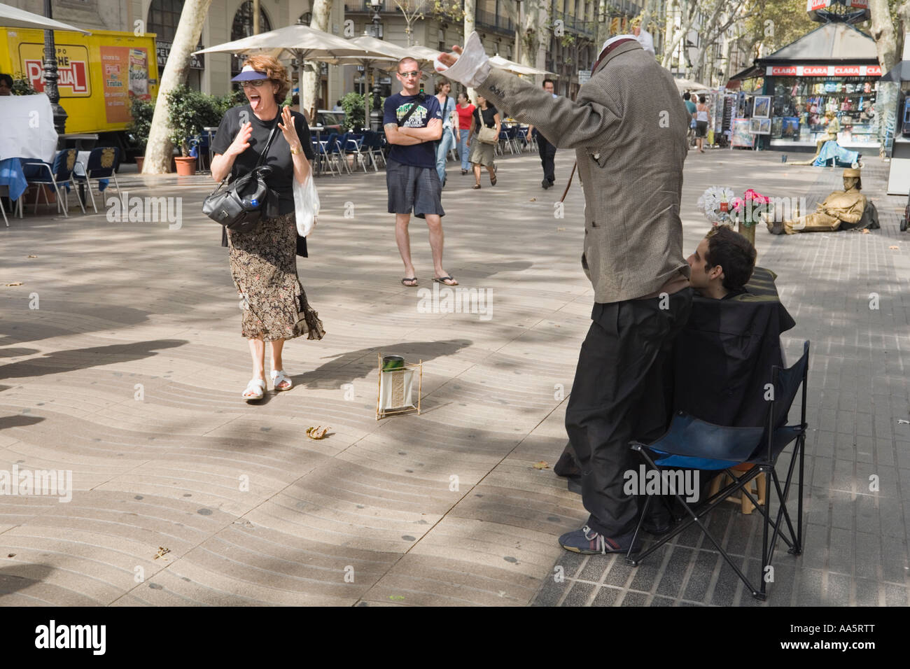 Barcelona, Spain. Headless act, street performers surprise a passerby on La Rambla Stock Photo