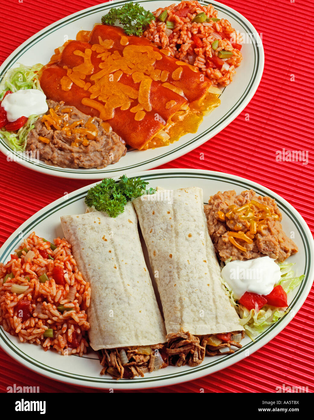 two plates mexican style burritos refried beans rice sour cream tomato