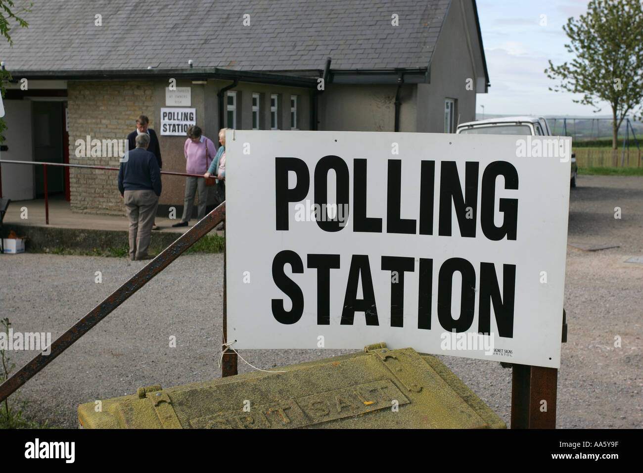 People exit a British general local election polling station in a quiet rural village community centre South Devon England UK GB Stock Photo