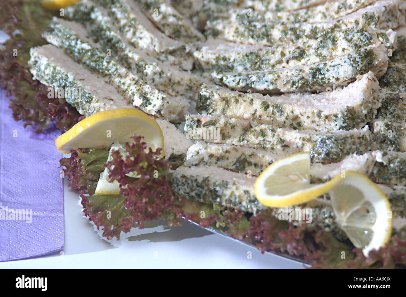 ANG103870 Food Fish pate oven backed fish mince with herbs garnished with Lollo Rosso Salad leave and lemon Sweden Stock Photo