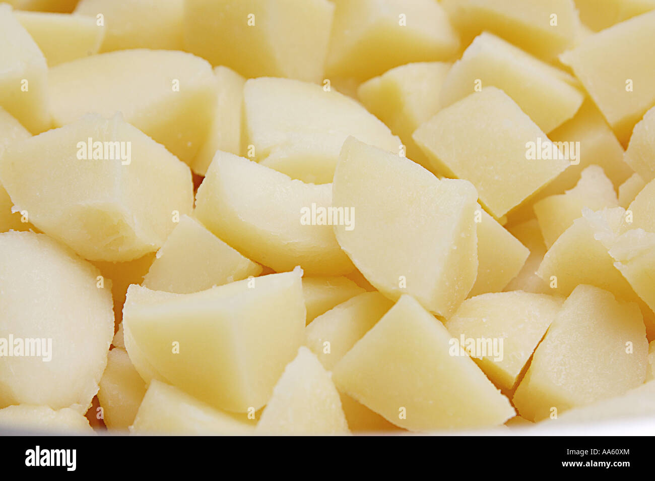 Boiled potatoes cooked cut in triangular pieces Stock Photo