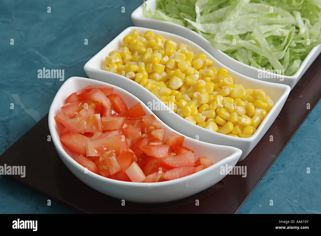 Salad tray, chopped tomatoes, sweet corn, iceberg salad chopped Stock Photo