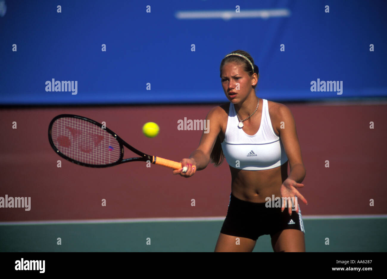 Anna Kournikova in a white crop top volleys at the net during a practise session in Hong Kong Stock Photo