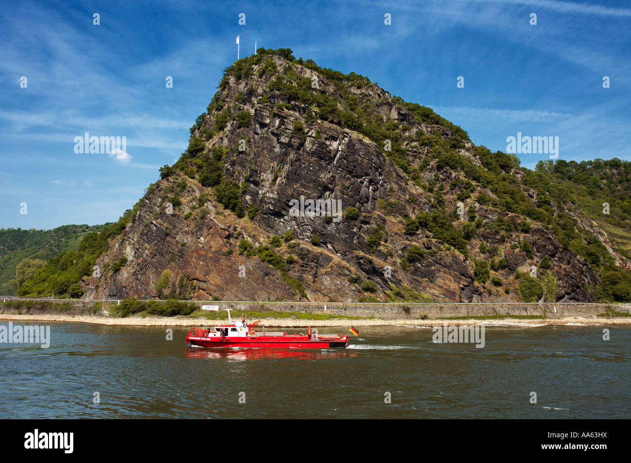 The Lorelei rock and fireboat in the River Rhine valley, Rhineland, Germany, Europe Stock Photo