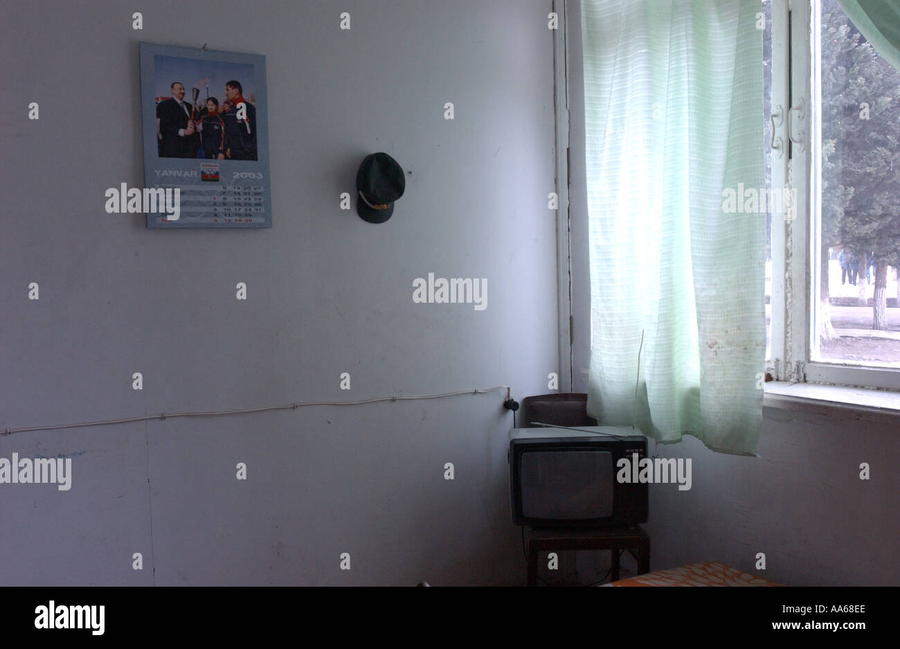 Imishli Distric Azerbaijan January 12 2003 An office stands empty except for a calender television and hat for a government Stock Photo