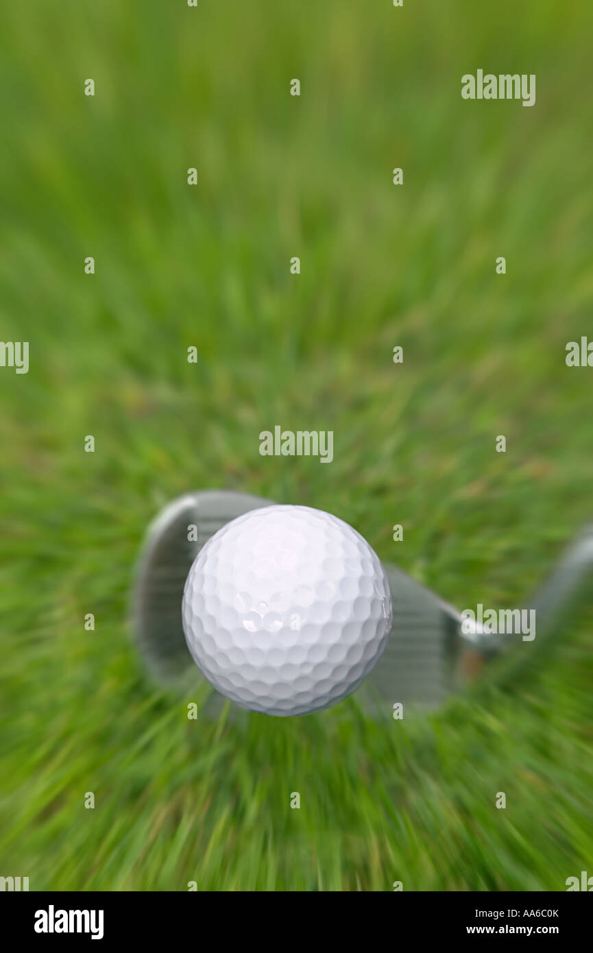 Golf ball frozen in mid air after an iron shot Stock Photo