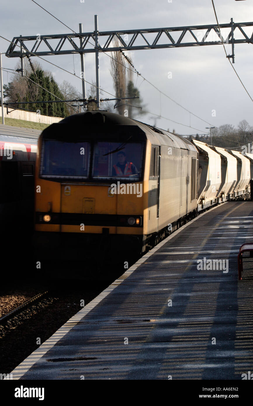 Freight train passing through Crossflatts station passenger train