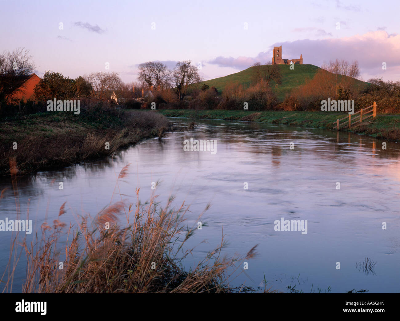 The River Parrett swollen by winter rain flows past Burrow Mump near ...