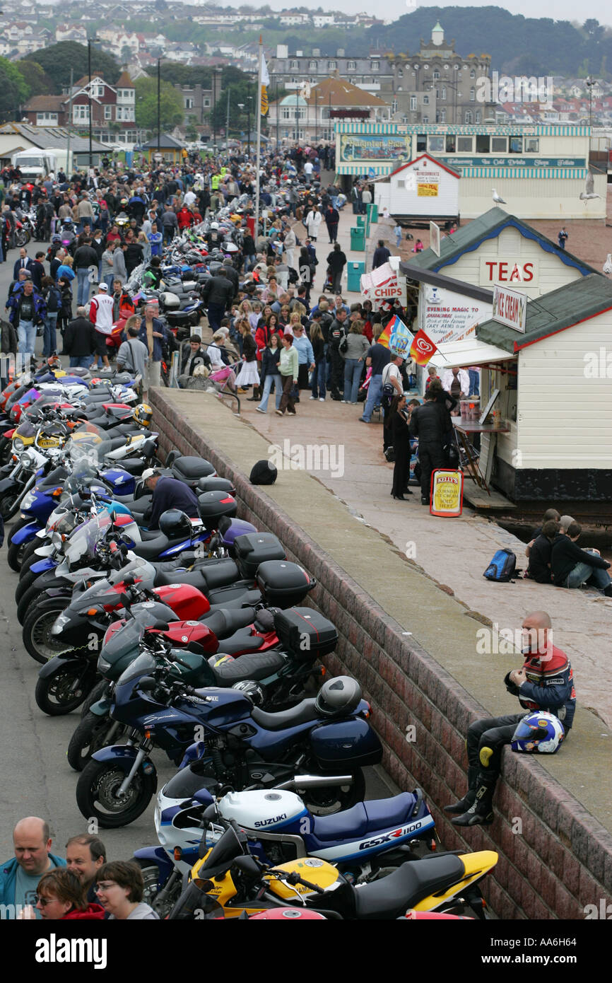 A lone leather clad biker sits on the seawall at the Paignton Motorbike