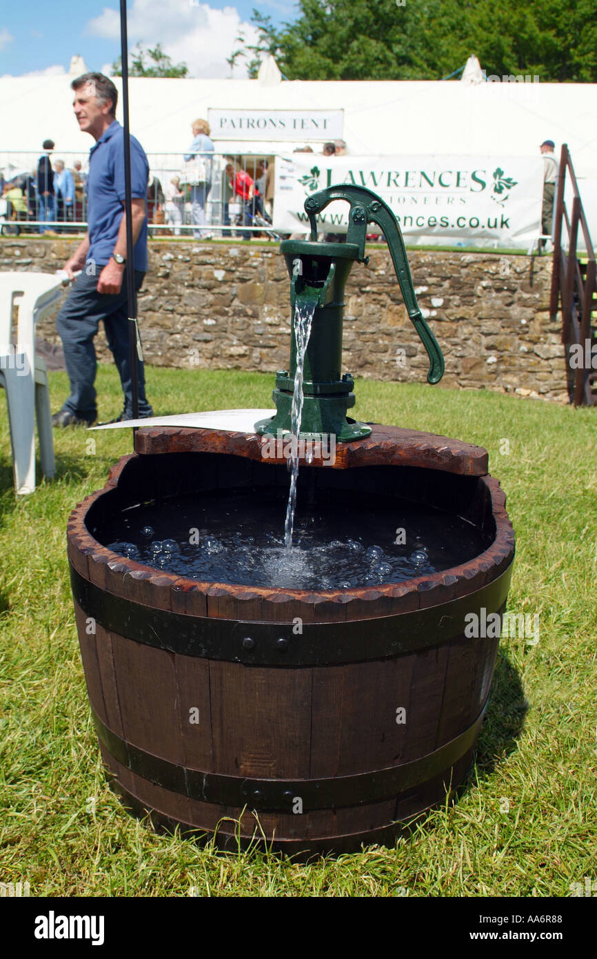 A hand cranked waterpump now a novelty water feature Stock Photo