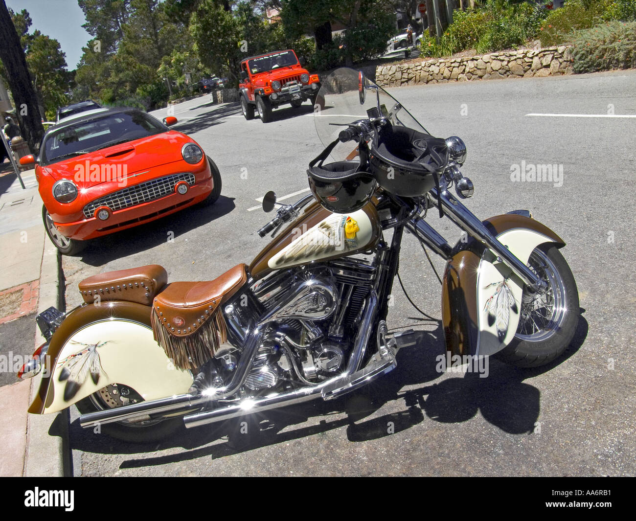 Americana ; Harley Davidson parked on Ocean Avenue with Ford Thunderbird and Jeep behind Carmel  Monterey County California USA Stock Photo