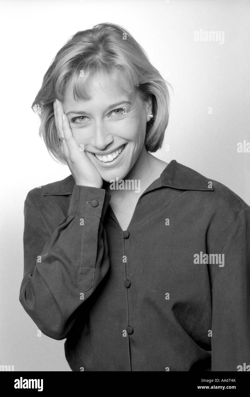 Happy smiling woman with her hand on her face Stock Photo - Alamy