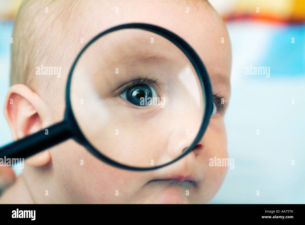 Baby looking through magnifying glass Stock Photo Alamy
