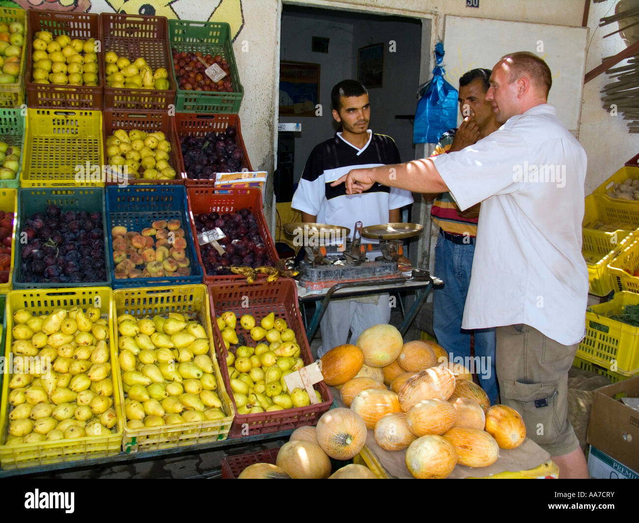 Tourist buys fruit at road side shop Tunisia Stock Photo