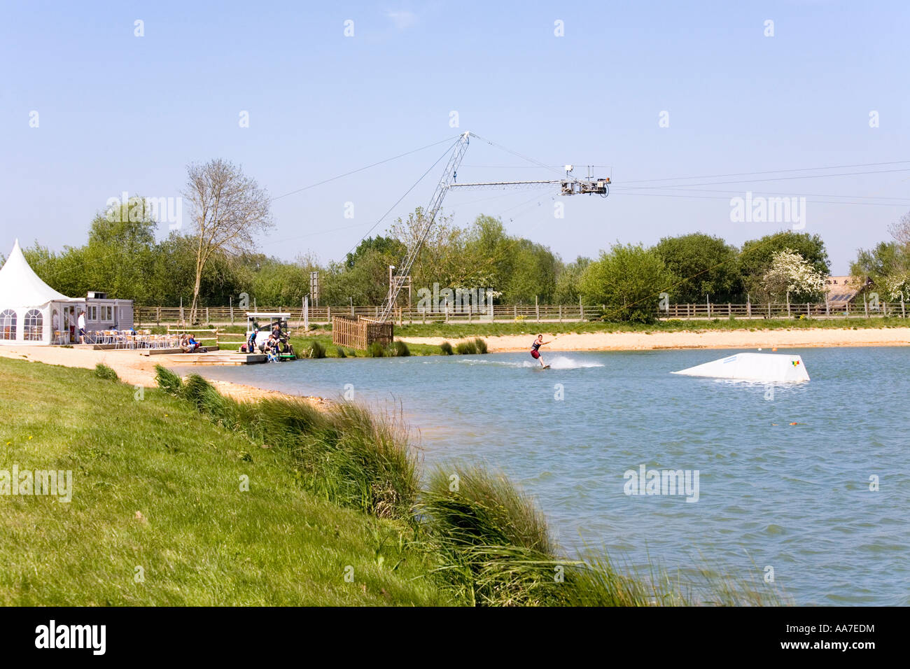 Wake boarding with a cable tow at Watermark Ski, Cotswold Water Park, South Cerney, Gloucestershire Stock Photo