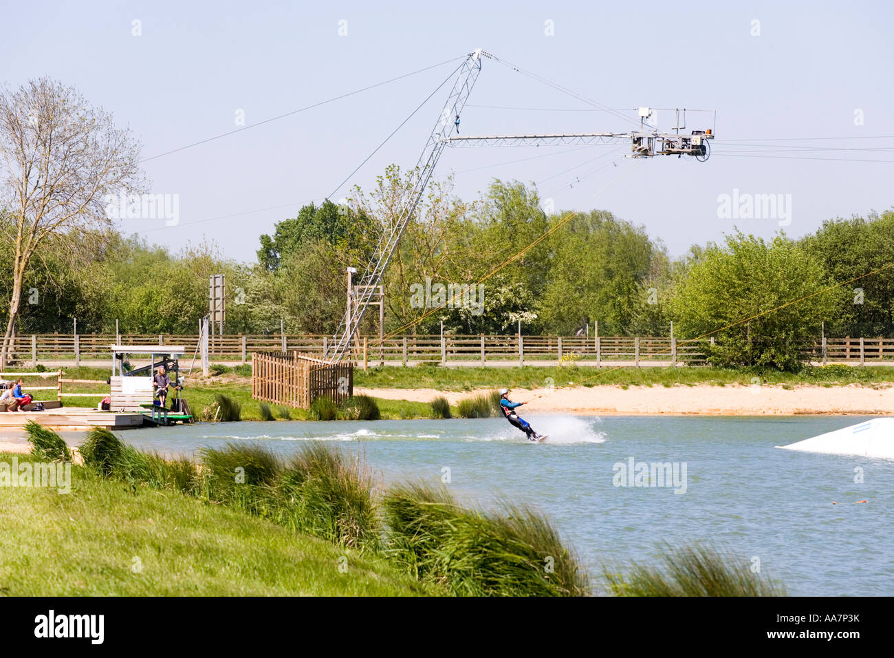 Wake boarding with a cable tow at Watermark Ski, Cotswold Water Park, South Cerney, Gloucestershire Stock Photo