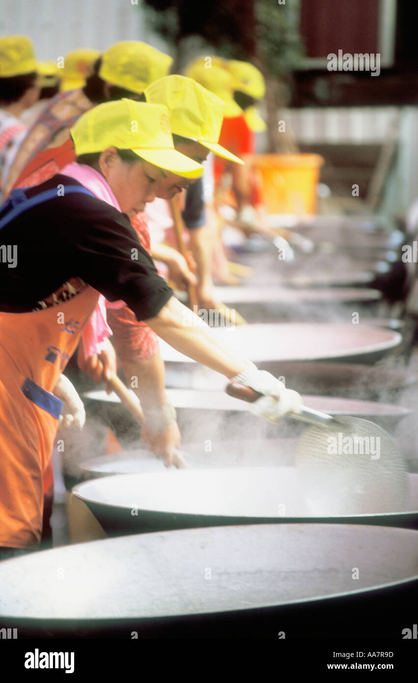 Row Of Chinese Women Cooking In Giant Woks Taiwan China Stock Photo