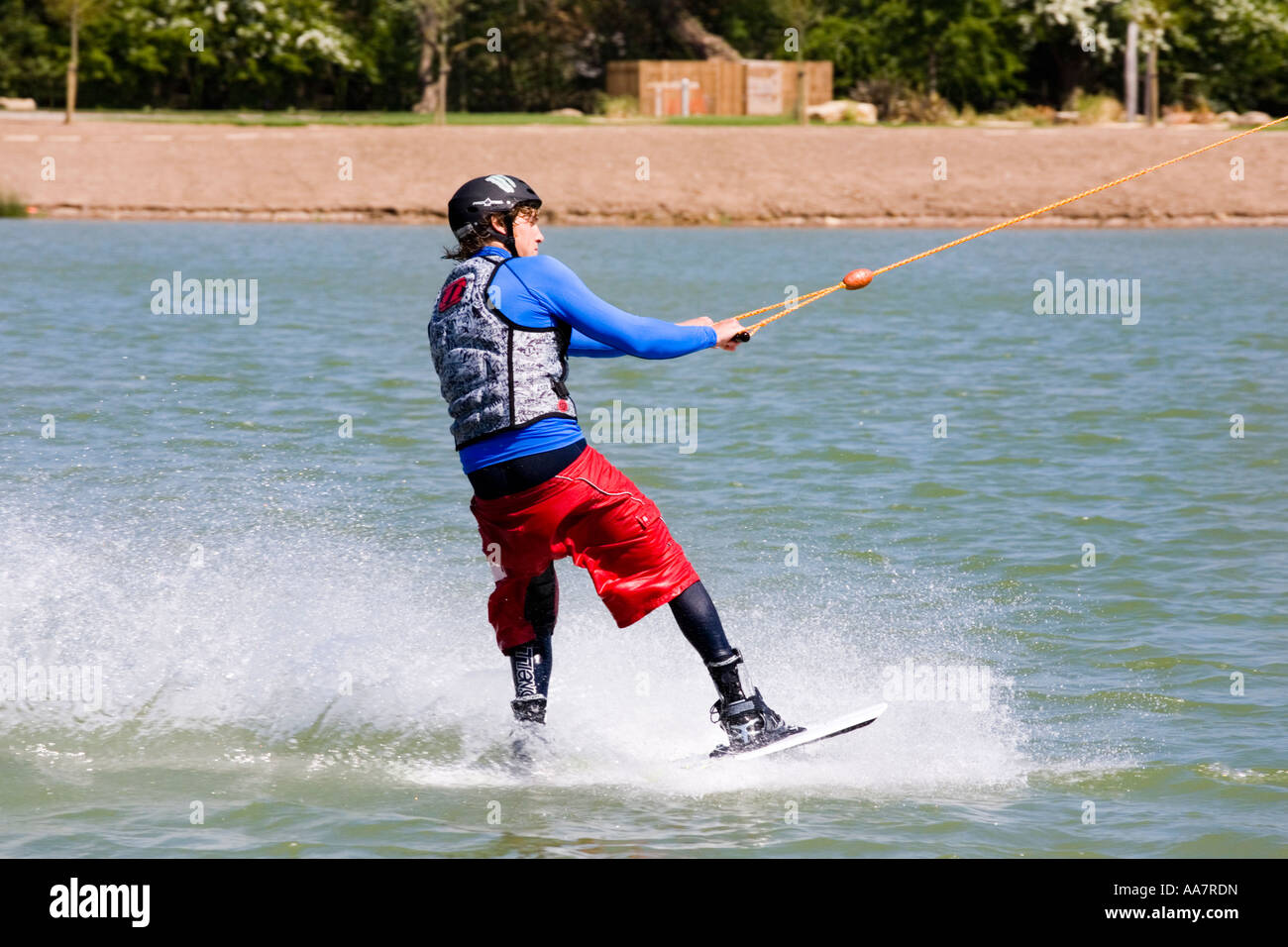 Wake boarding with a cable tow at Watermark Ski, Cotswold Water Park, South Cerney, Gloucestershire UK Stock Photo