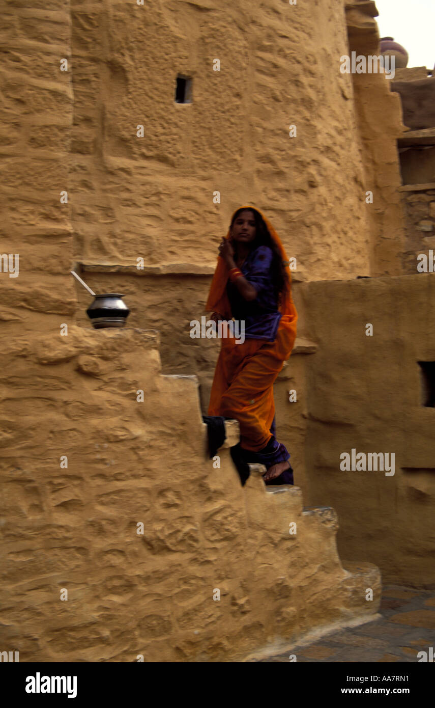 Young woman climbing staircase to her home, Jaisalmer Fort, Rajasthan, North India Stock Photo