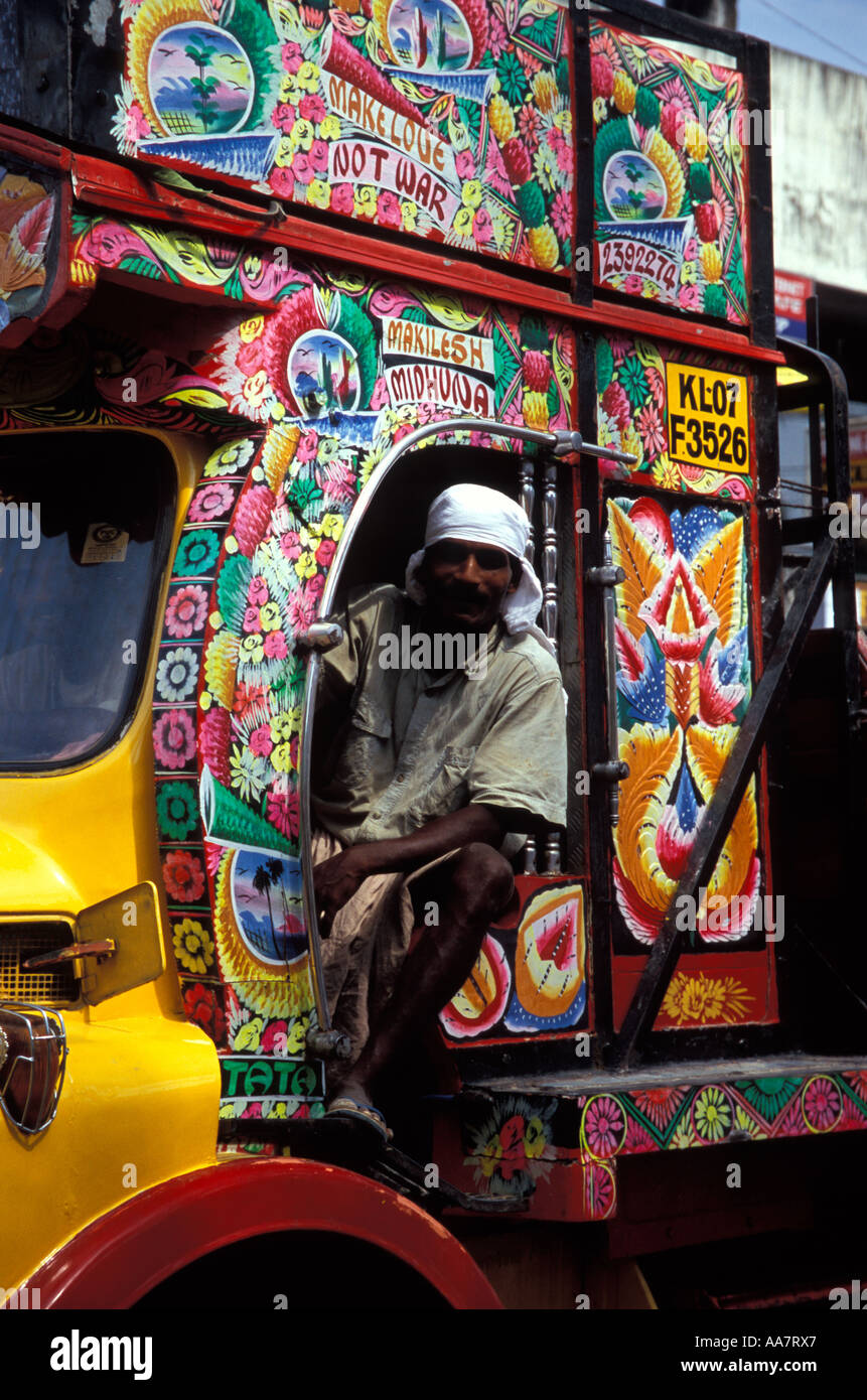 Indian truck driver on flamboyantly painted truck encouraging 'Make Love Not War', Balaramapulam, Kerala, South India Stock Photo