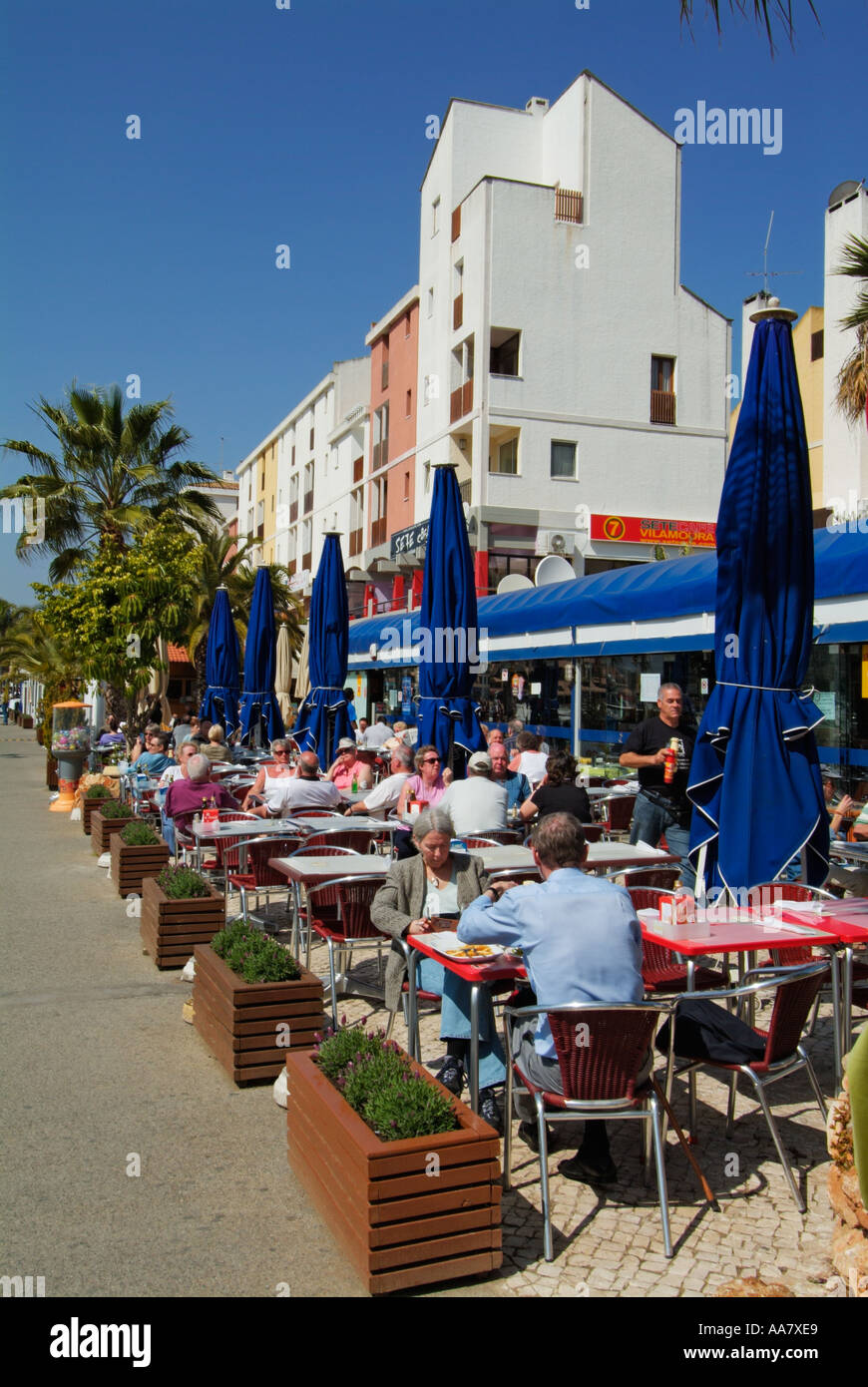 Diners in a cafe restaurant in the busy marina at Vilamoura Algarve Portugal EU Europe Stock Photo