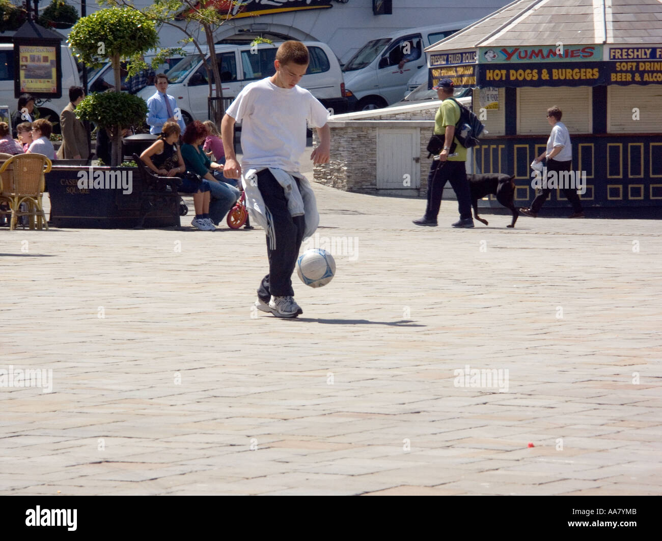 Boy playing football, Casemates Square, Gibraltar Stock Photo