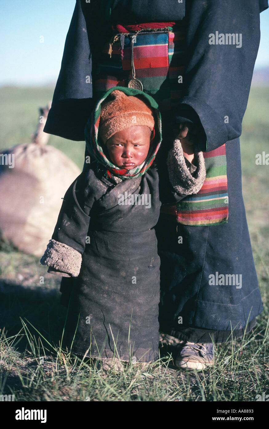 A year old Gyele on pilgrimage from Lhasa clings to his mother s apron strings Kailash Stock Photo