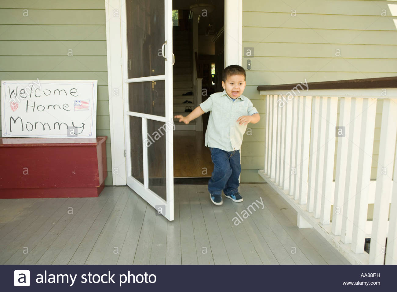 Hispanic Boy Running Out Front Door Stock Photo 12546964 Alamy
