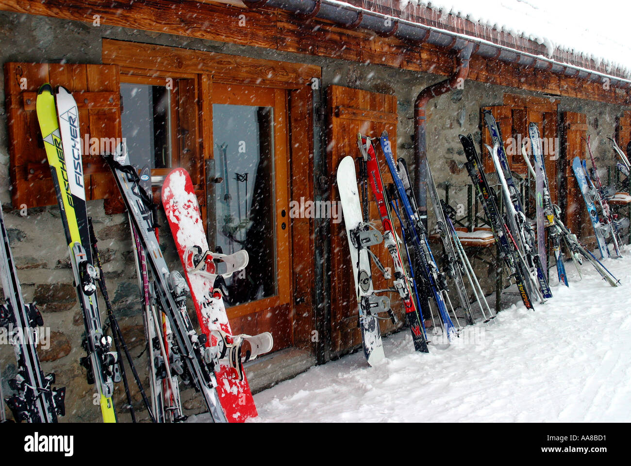 Skis and snowboards stacked outside a mountain restaurant Switzerland Stock Photo