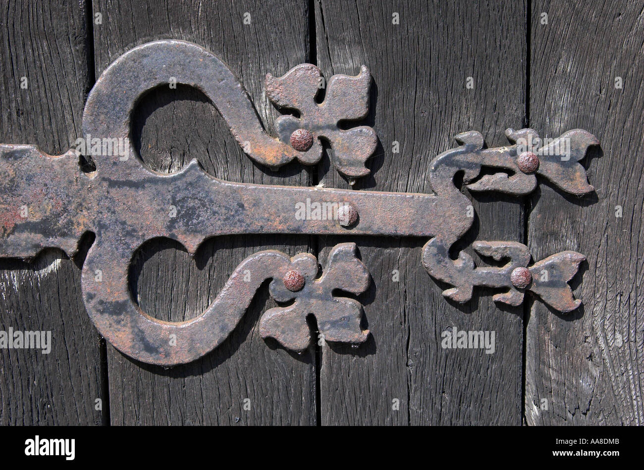 Ornate iron hinge on the door of the old Pump House, Walsingham, Norfolk, England Stock Photo