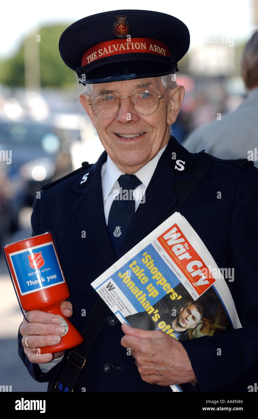 A Salvation Army man selling War Cry in the street Britain UK Stock Photo