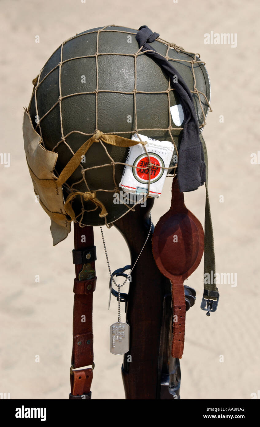 An American helmet on a rifle marking where a fallen soldier is buried Stock Photo