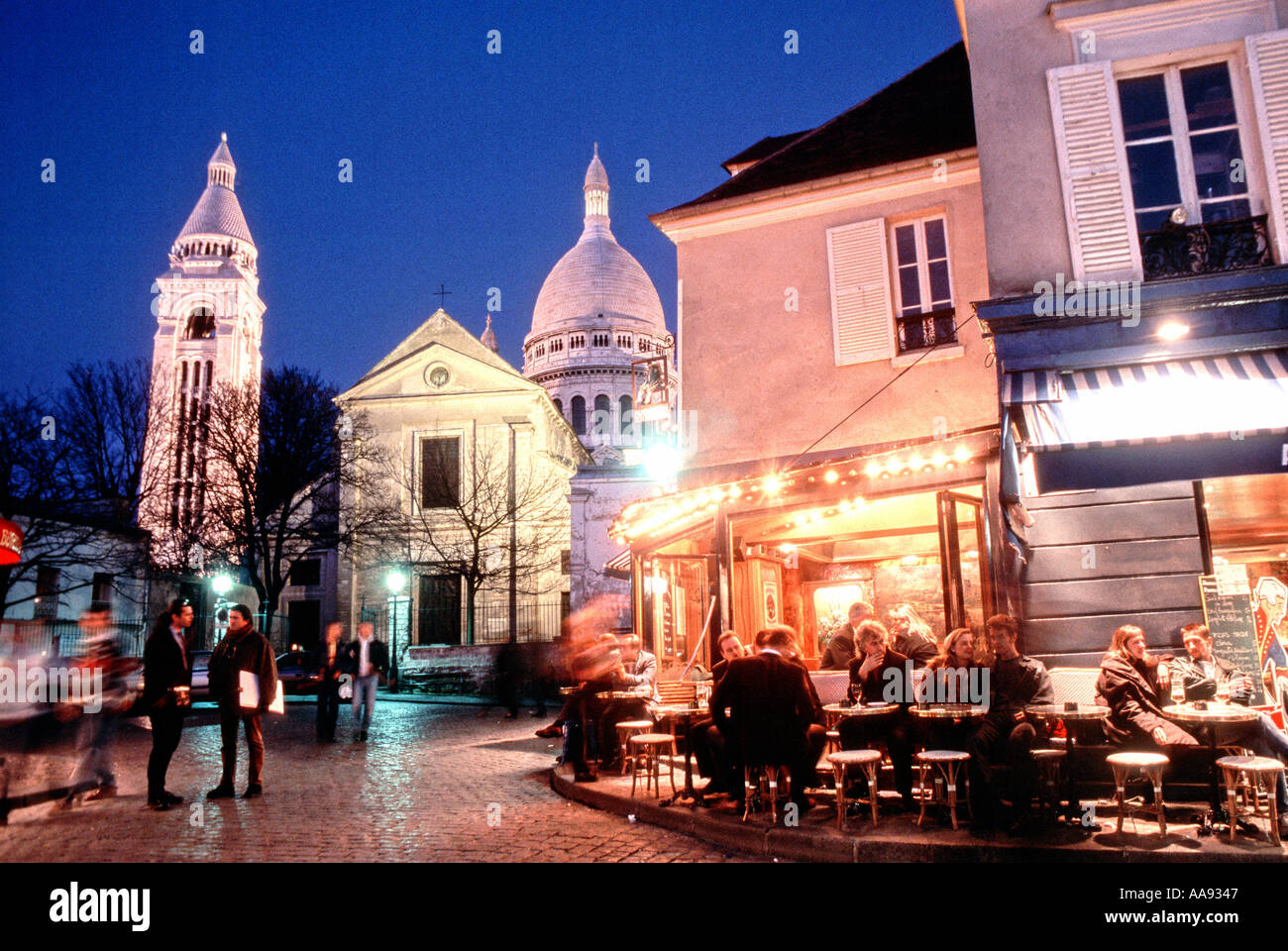 Romantic PARIS France French Restaurant Terraces 'Place de Tertre' in Montmartre, Lit up at Night 'Sacre Coeur Basilique » saint pierre of montmartre Stock Photo