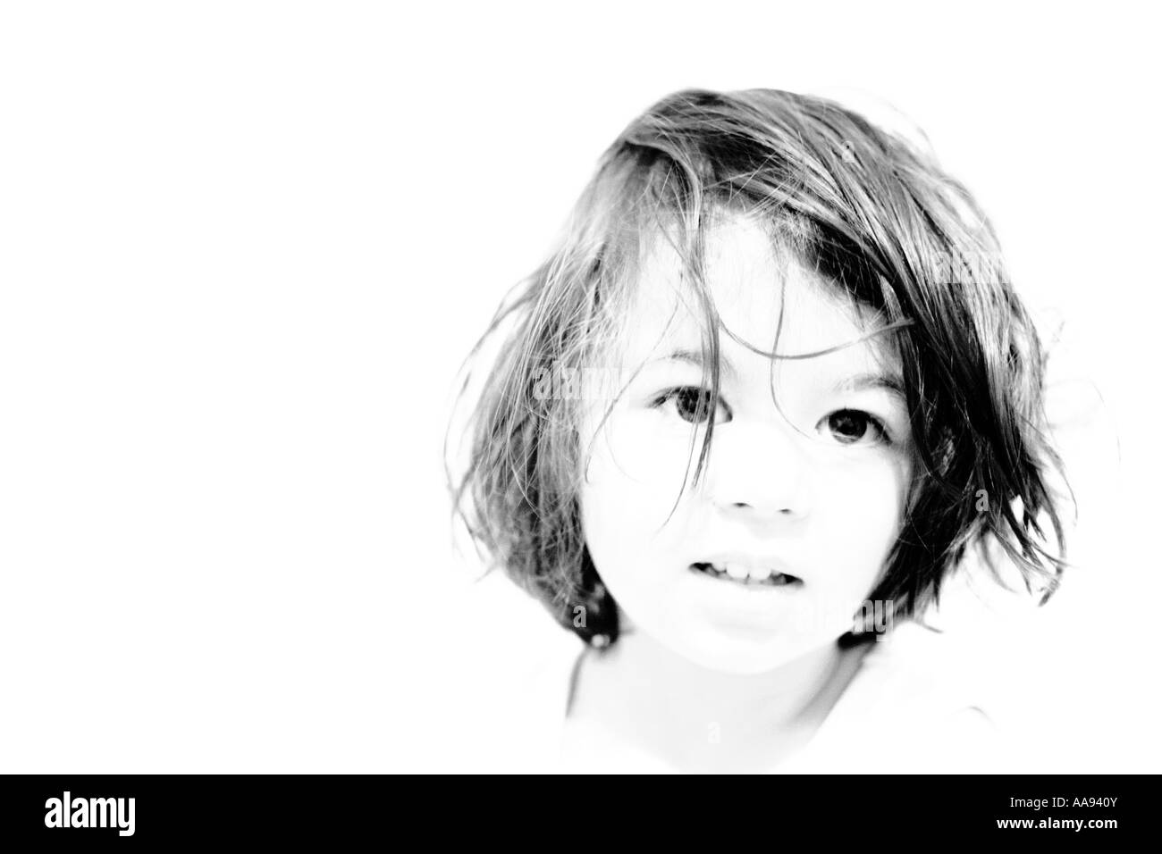 Head and shoulders high key portrait of a young girl, black and white Stock Photo