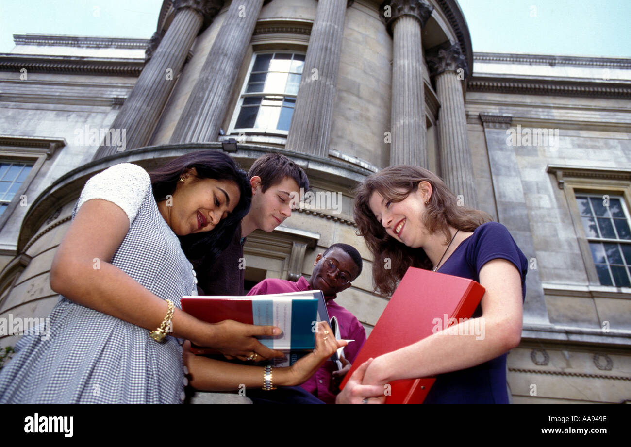 Group of university students standing chatting outside on campus. Stock Photo